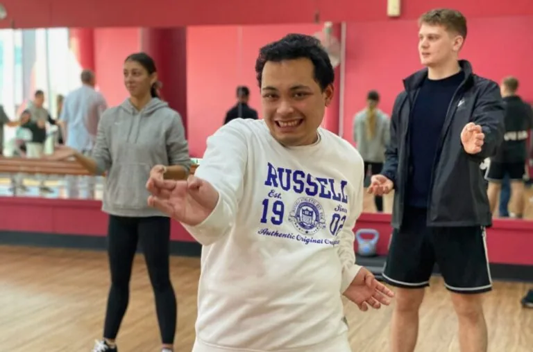 Day program participants dancing together in a studio