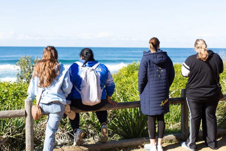 Participants taking in the ocean view from a lookout at Palm Beach
