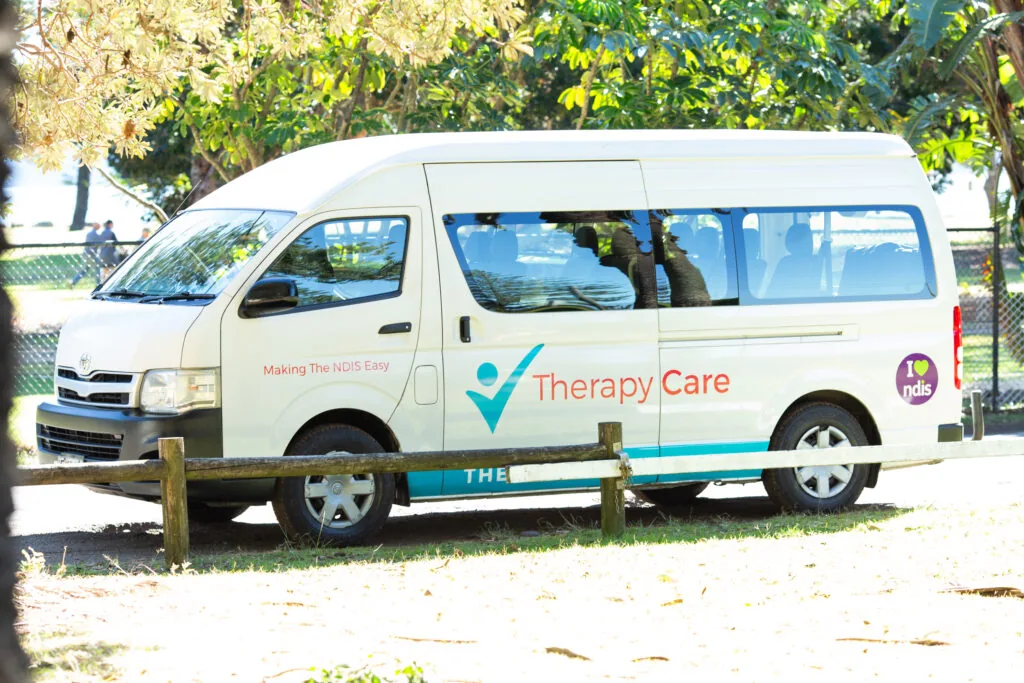 A Therapy Care van parked at a park on a day out
