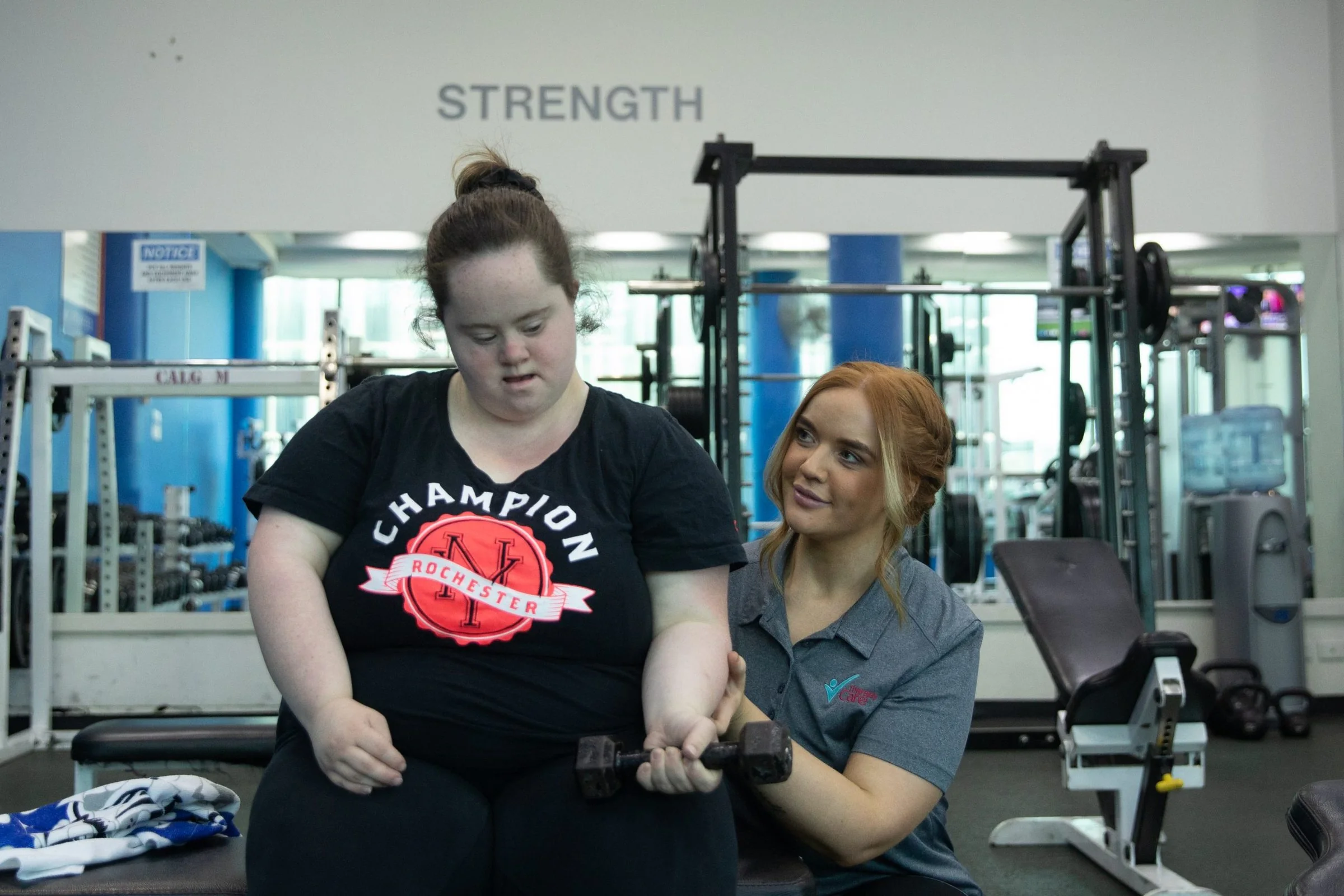 A physiotherapist working with a participant in the Therapy Care gym